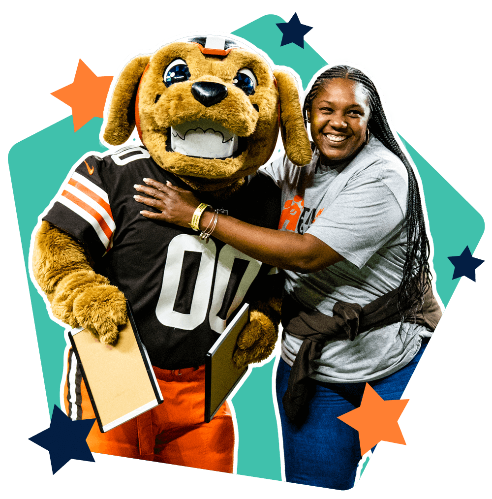 School educator hugging Cleveland Browns mascot  Chomps
