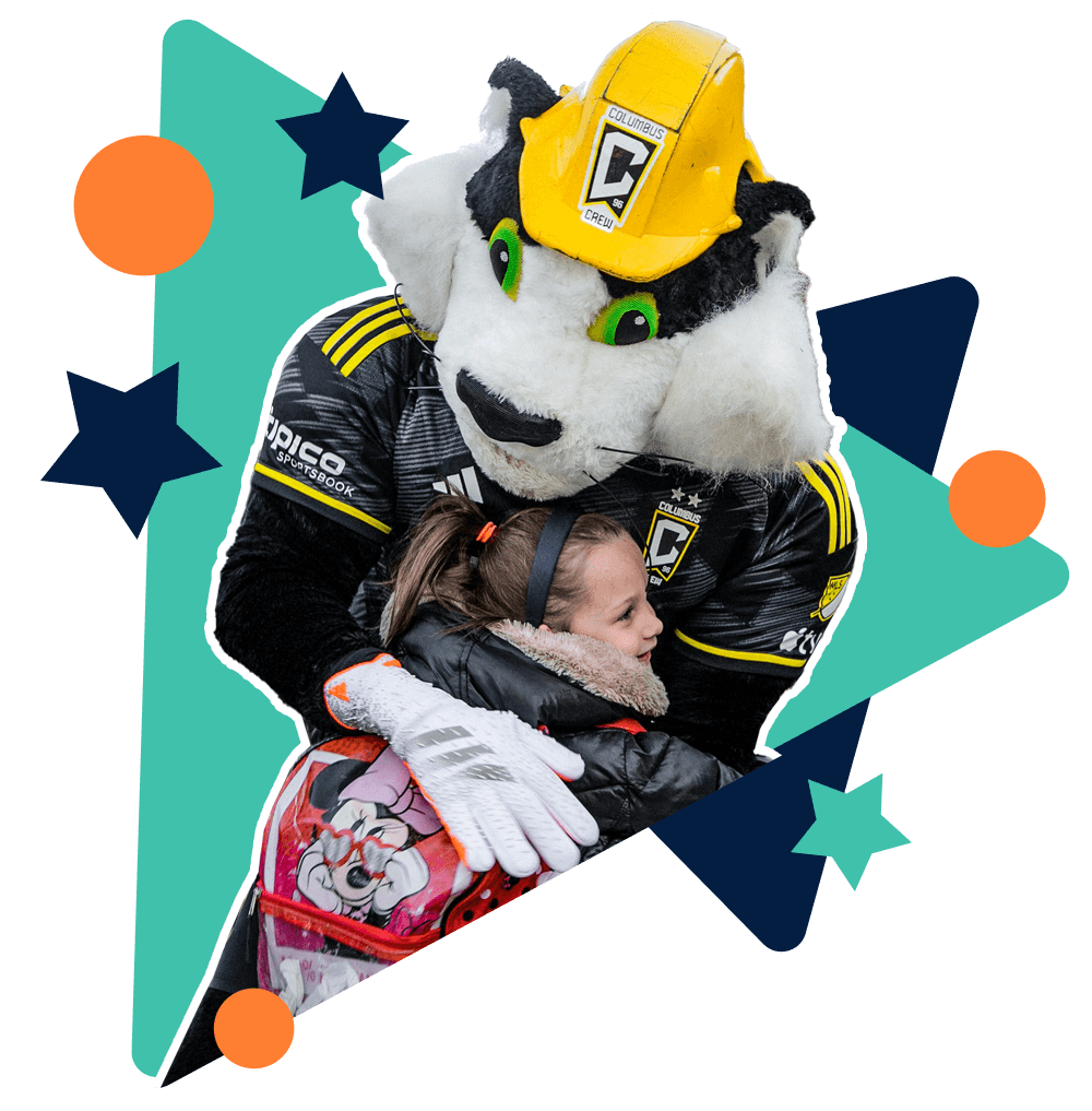 Student hugging Columbus Crew mascot